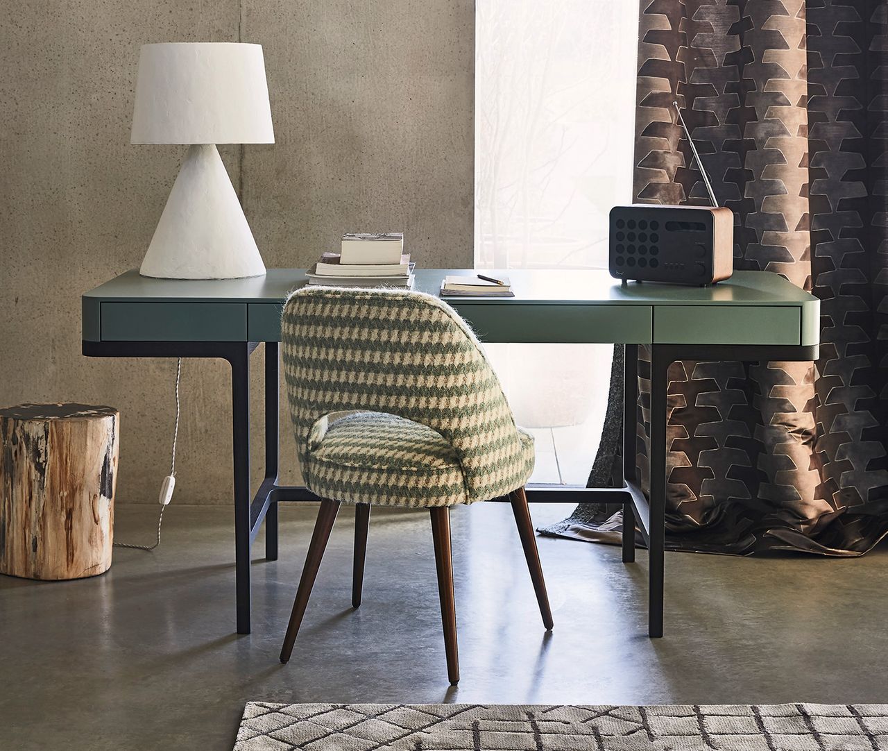 grey desk in a modern home office with patterned chair