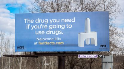 A billboard advertising naloxone is seen in St. Paul, Minnesota.