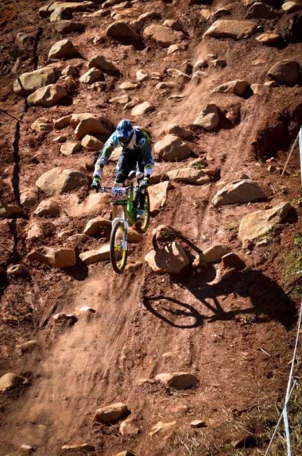 A downhill rider flies over the rock garden.