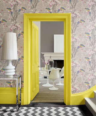 grey floral wallpaper in hallway with yellow paintwork on skirting and trim