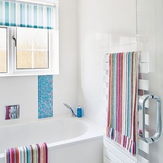 White bathroom with colourful accents help to buy 35 year mortgage