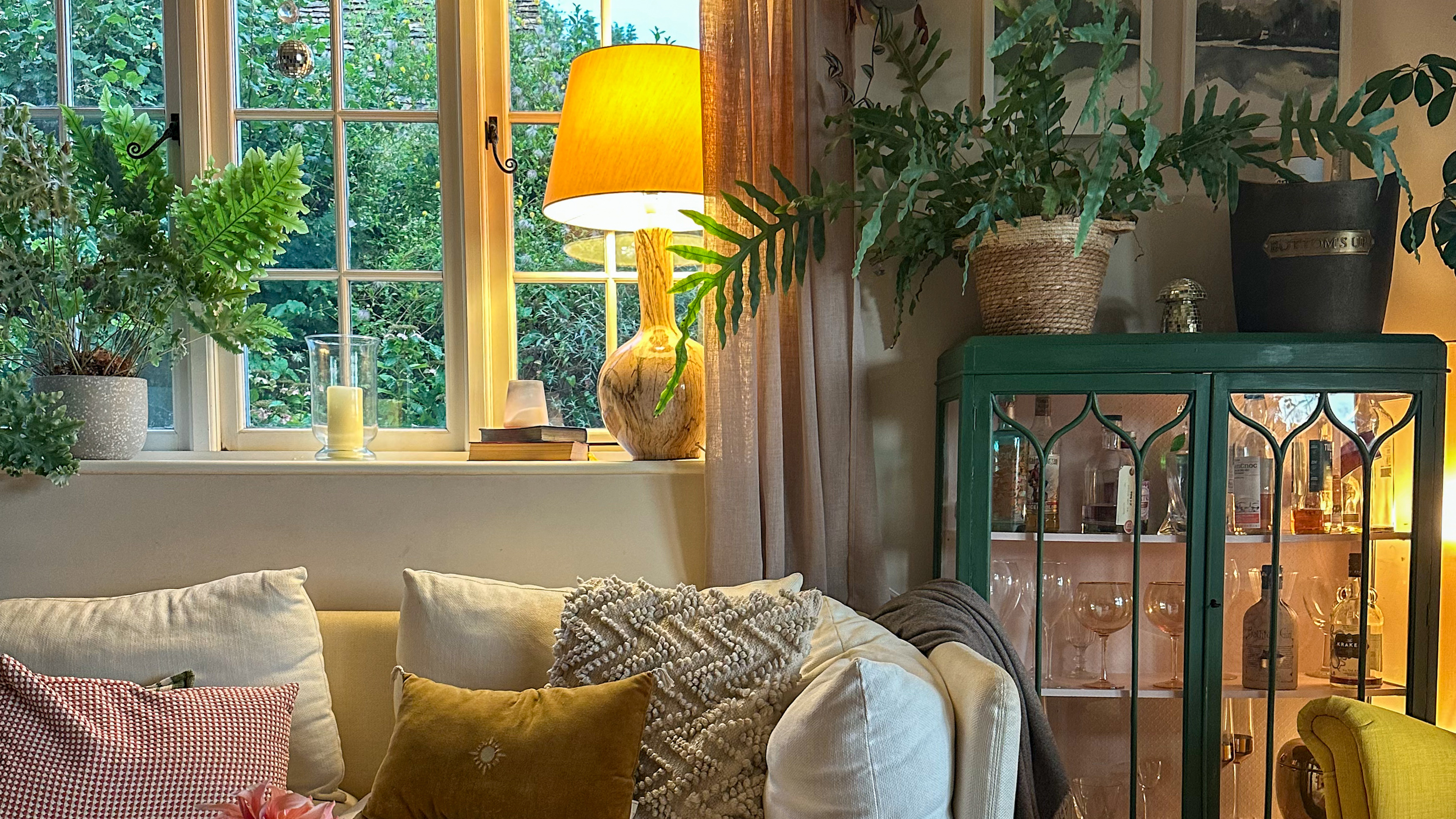 country living room lit by a warm yellow table lamp