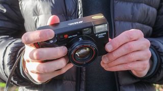 Canon AF35ML point and shoot film camera in hands of our reviewer