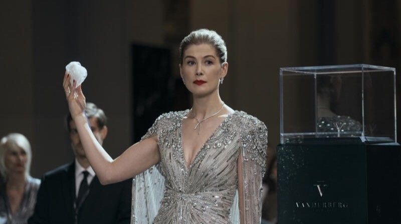 Rosamund Pike holding a diamond in Now You See Me: Now You Don't