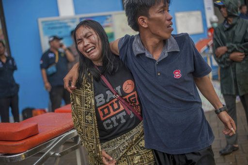 A woman reacts after identifying a relative among the bodies of tsunami victims in Carita, Indonesia, Sunday, Dec. 23, 2018. 