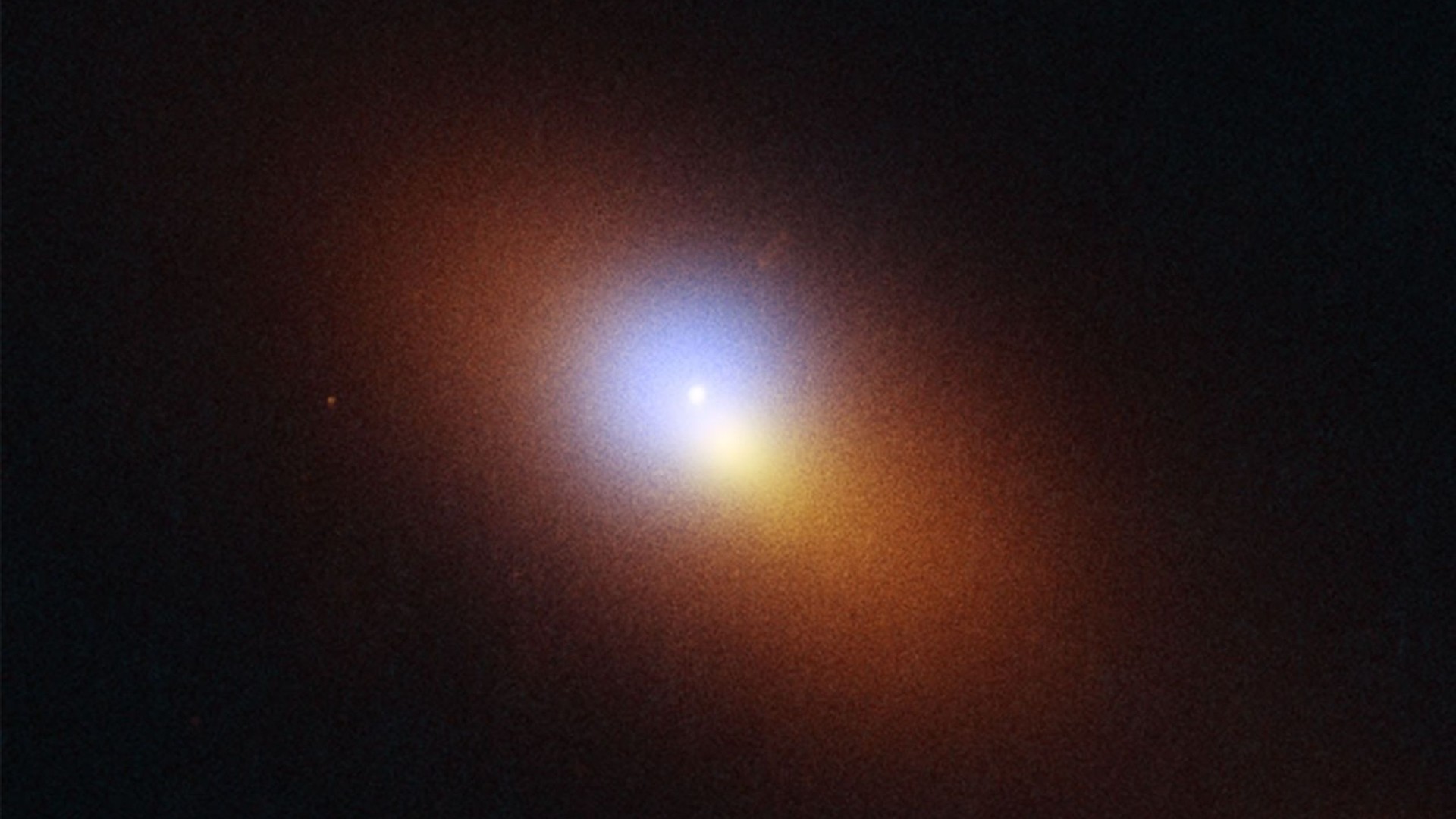a pink and orange cloud of light with a bright pinpoint in its center