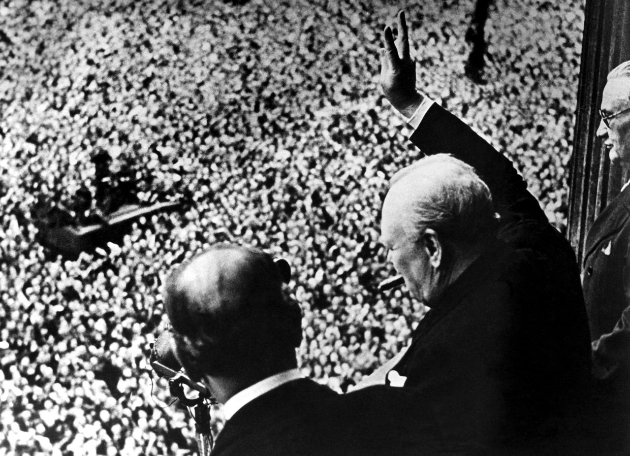 Prime Minister Winston Churchill gives his famous V for Victory sign to a crowd of 50,000 full with the spirit of VE day from the balcony of the Ministry of Health, London 8th May 1945. Picture: Topfoto/PA