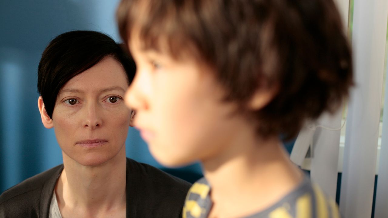 tilda swinton looks at a little boy with concern in a still from we need to talk about kevin