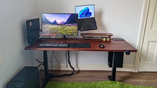 A monitor and laptop attached to the floating arm on the EverDesk Max