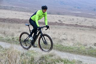 Ride on a gravel bike on a misty day in a yellow top on a trail