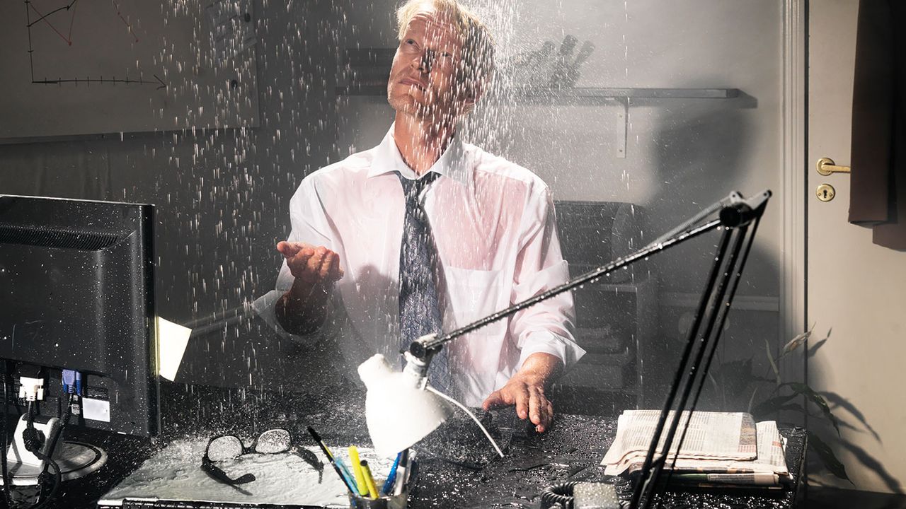 Businessman in flooded office