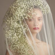 Bride wearing a wedding beauty look with a floral veil