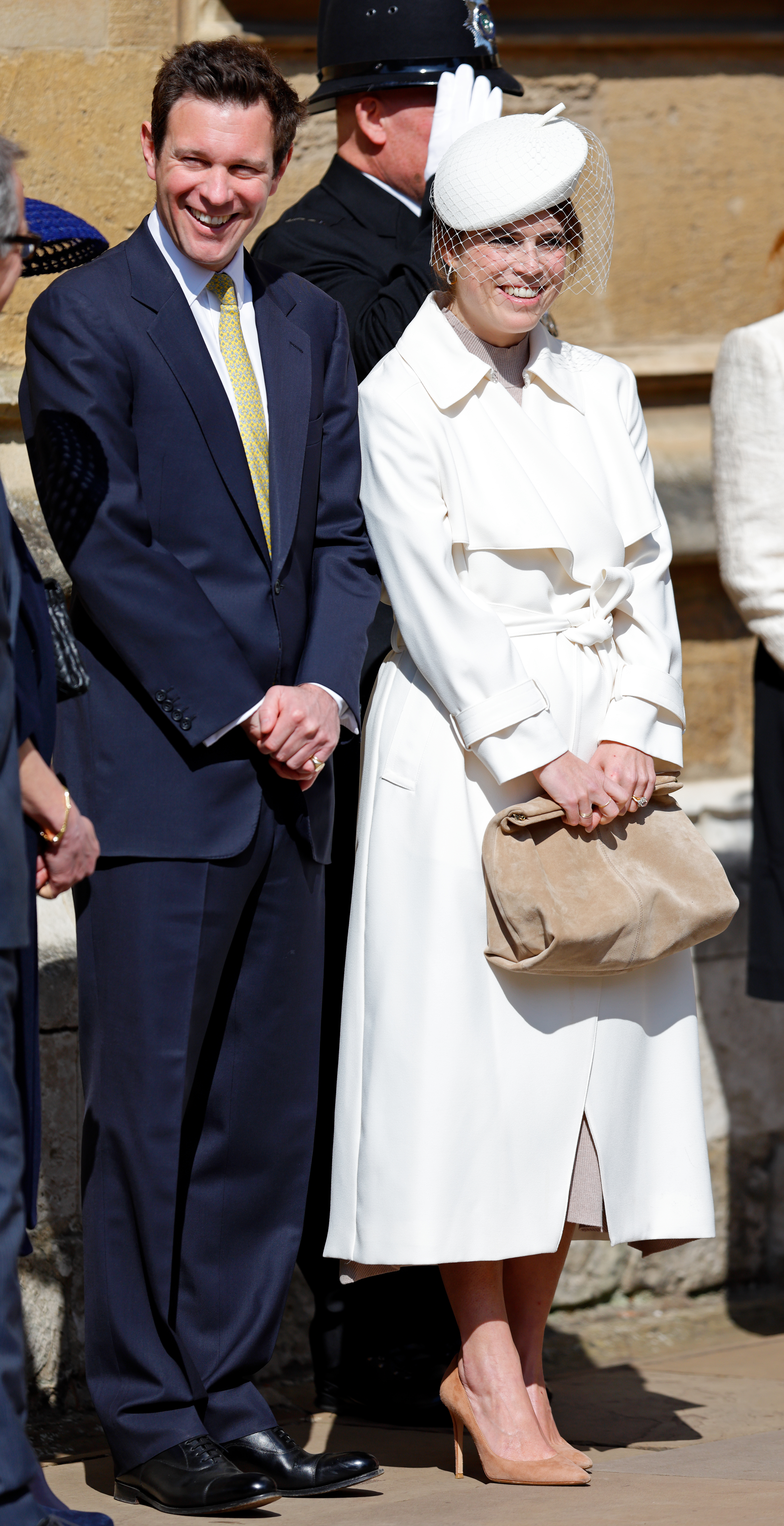 Princess Eugenie wearing a white coat and hat standing next to Jack Brooksbank on Easter 2025