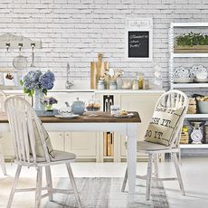 white furniture table chair pillow with brick wall