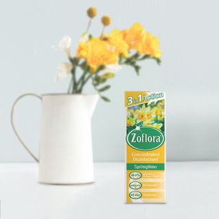 white mug yellow flowers and zoflora disinfectant