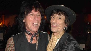 Jeff Beck posing for a photograph with Ronnie Wood