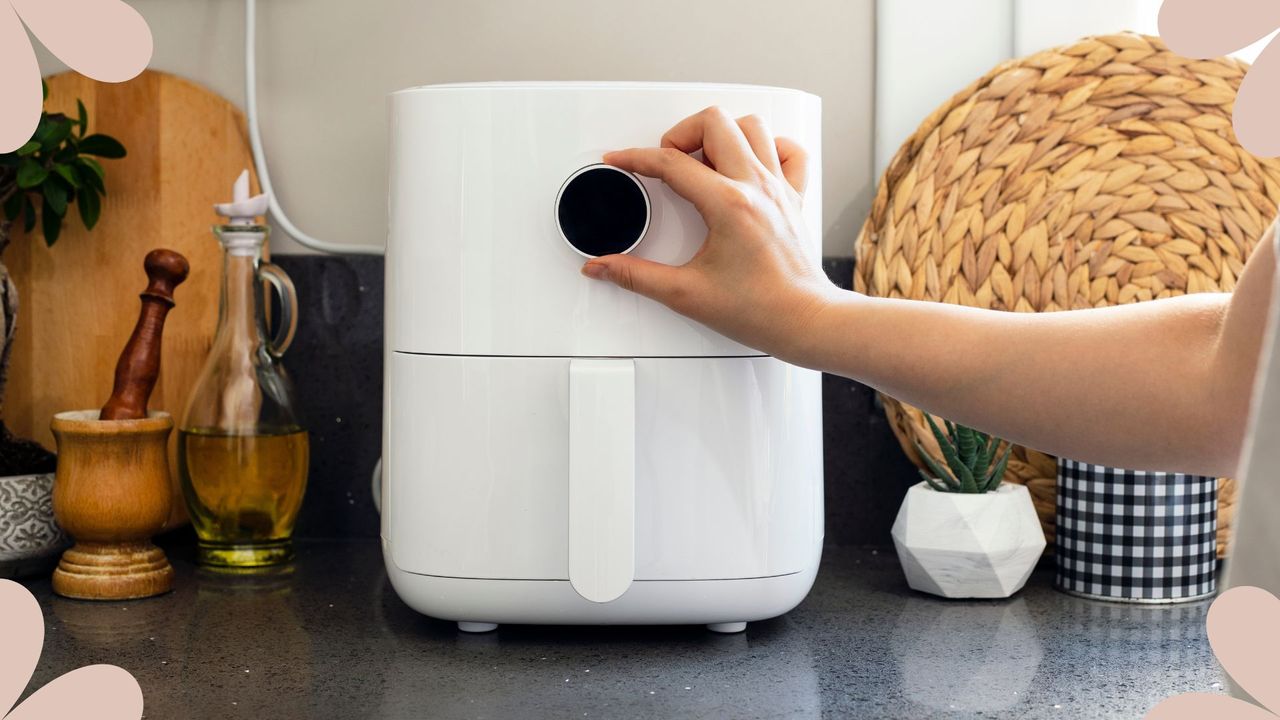 picture of woman using airfryer to support expert advice on how often should you clean your air fryer if you use it frequently