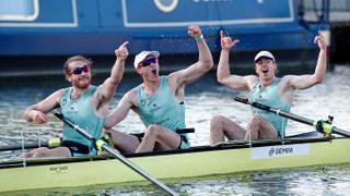 (L-R) Cambridge rowers Seb Benzecry, Ben Dyer and Theo Weinberger celebrate their win over Oxford at the finish of the 166th annual men's boat race between Oxford University and Cambridge University on the River Great Ouse in Ely, eastern England