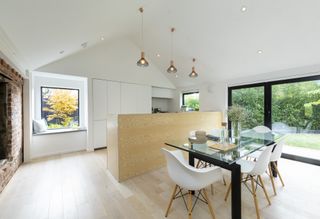 white kitchen extension with picture window and sliding doors