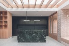 A kitchen with a stone island