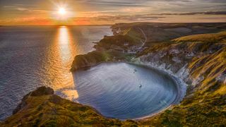 LULWORTH, UNITED KINGDOM - SEPTEMBER 25: (EDITORS NOTE: This image was processed using digital filters) An aerial view of the late summer sun as it sets over Lulworth Cove in Dorset on September 25, 2018 in Lulworth, United Kingdom. (Photo by Chris Gorman/Getty Images)