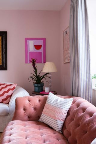 living room with pink walls and sofa