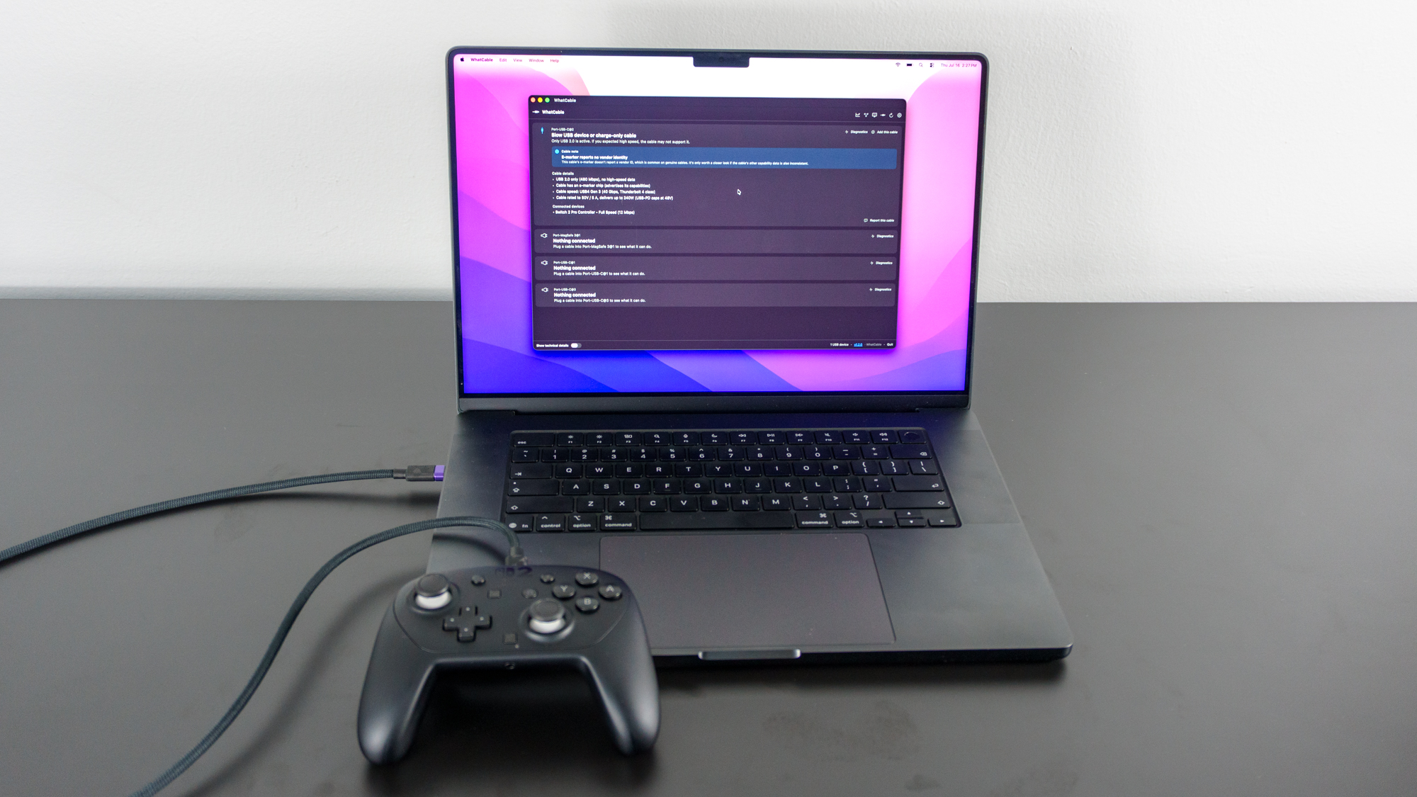 A Nintendo Switch 2 Pro Controller connected to a MacBook Pro running the WhatCable app