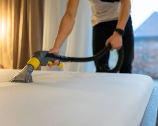 mattress being cleaned with vacuum