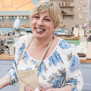 bake off contestant with floral top and apron