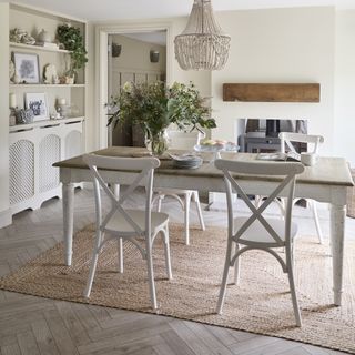 Kitchen dining room with farmhouse white table and rug underneath.