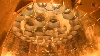 33 rocket engines spit fire under a launch stand.