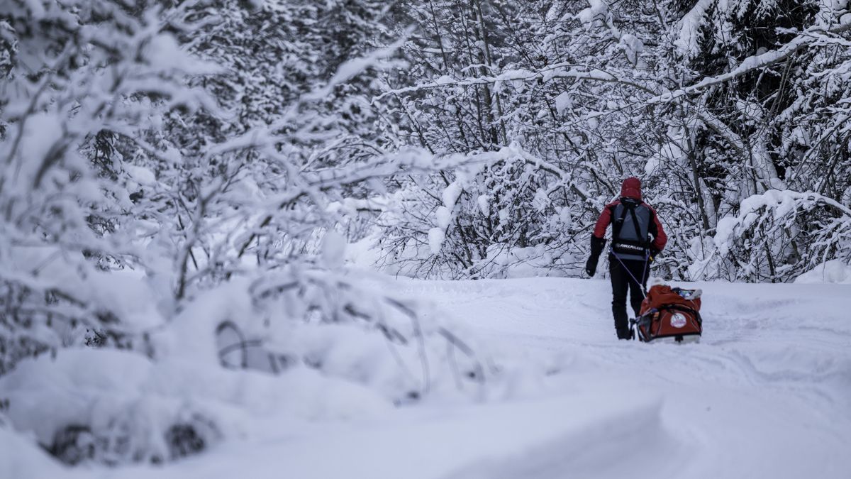 An ultra runner pulls a sled in the snow in the Montane Yukon Arctic race 2025