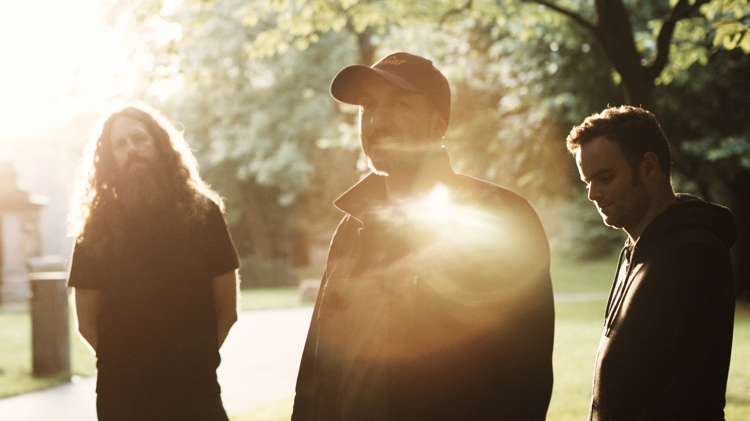 Mugstar group shot in a graveyard with lens flare