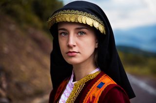  DELPHI, GREECE. On a normal day, Eleni works in her family’s restaurant. But once a year, she dresses like this for Easter. It’s fascinating to see that, despite the fact that Greece is a modern country, it preserves many of its ancient traditions. 