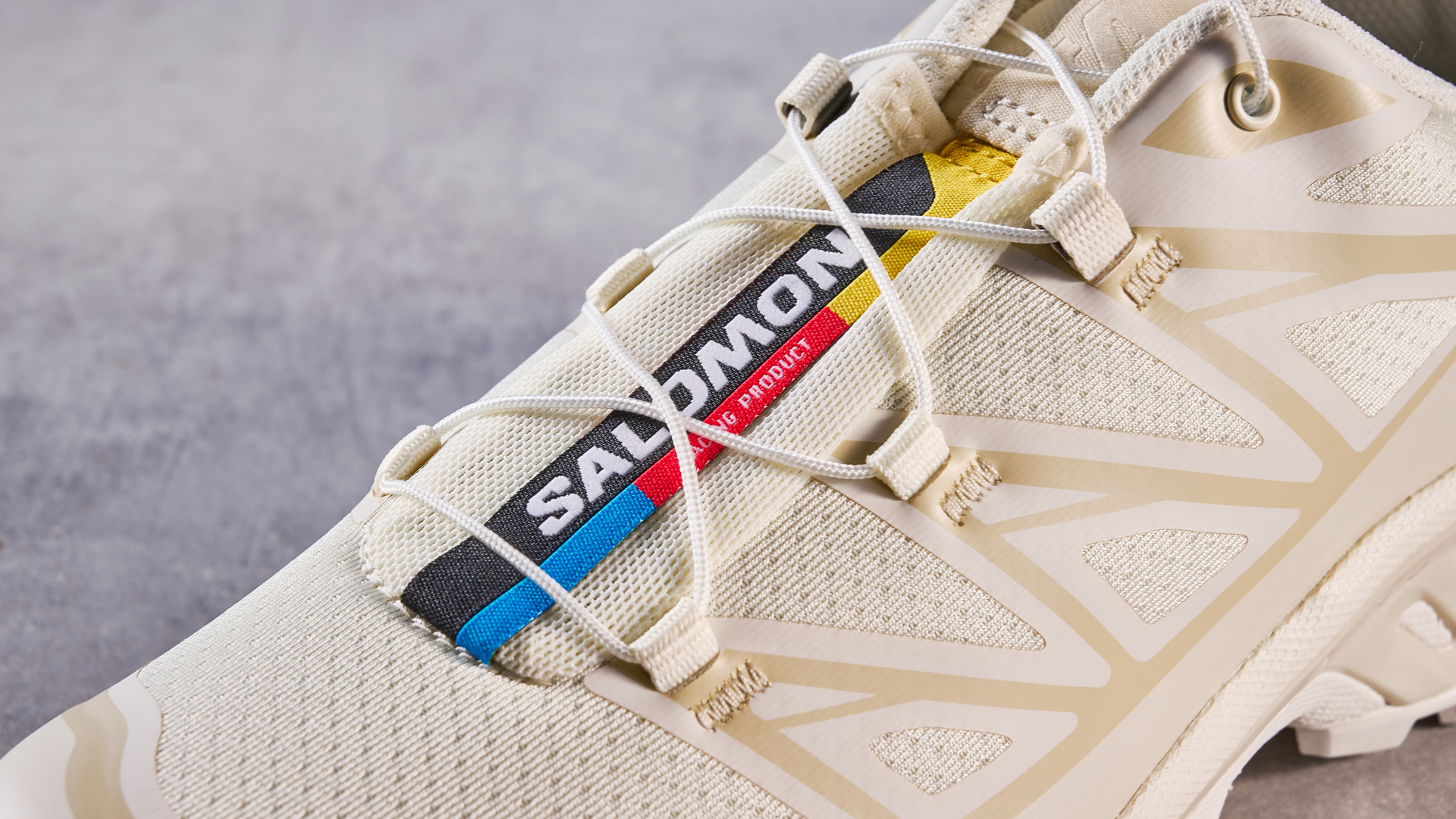 Salomon XT-6 in Vanilla Ice photographed in front of a blue background