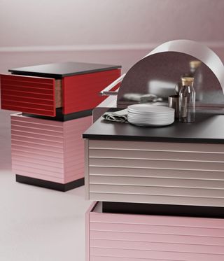 Pink kitchen units with plates stacked on top