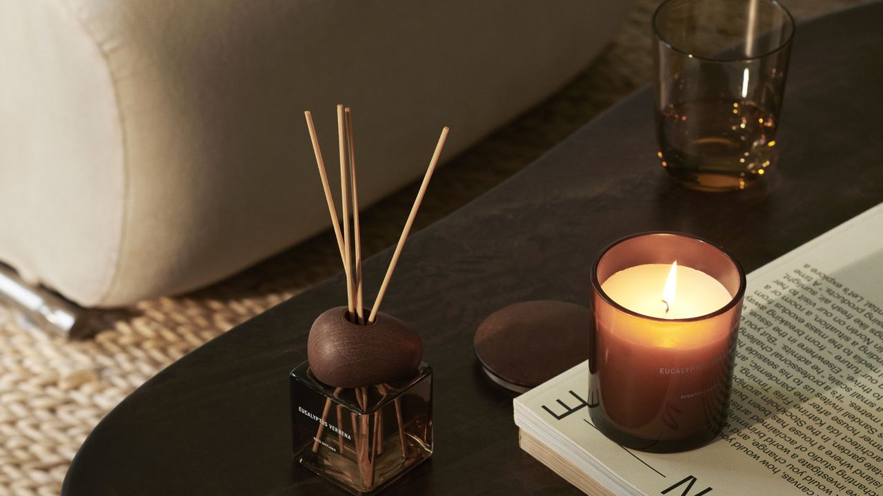 H&amp;M Home furniture and lamps US launch campaign image with brown coffee table, candle and reed diffuser