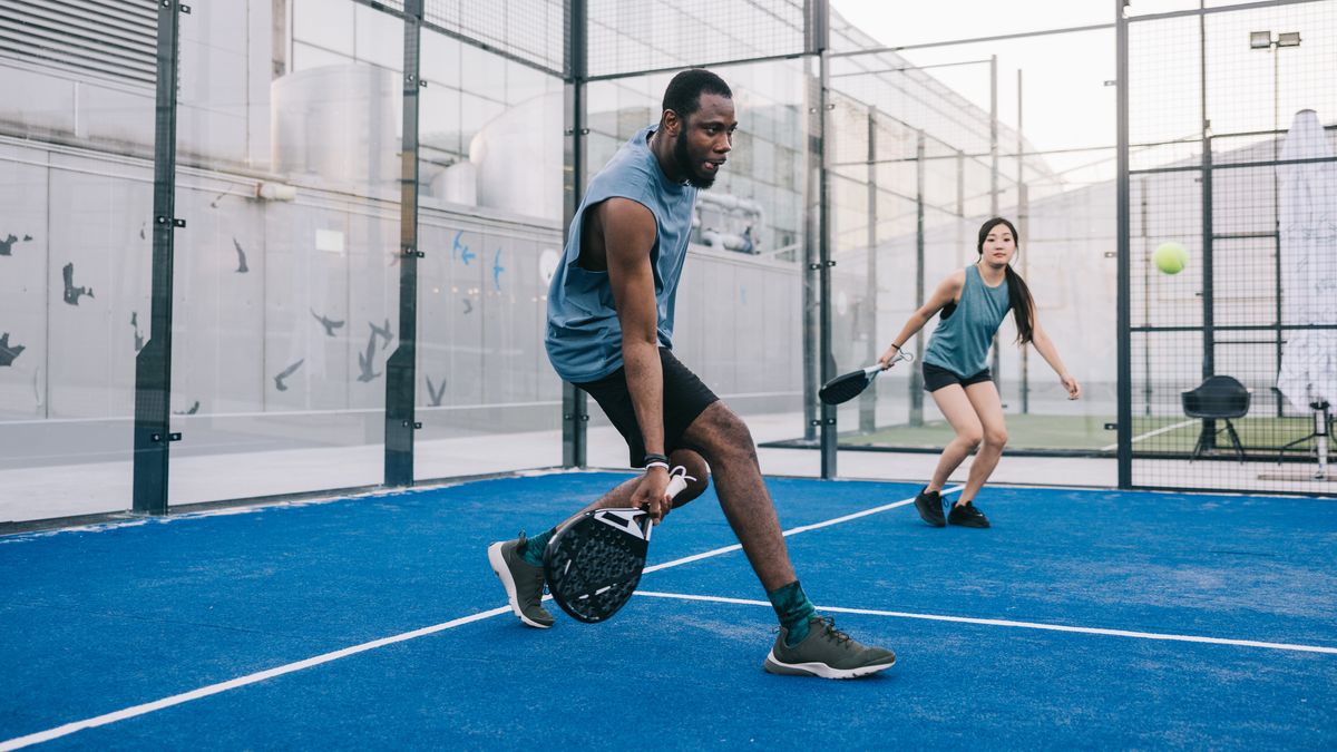 Man and woman playing padel