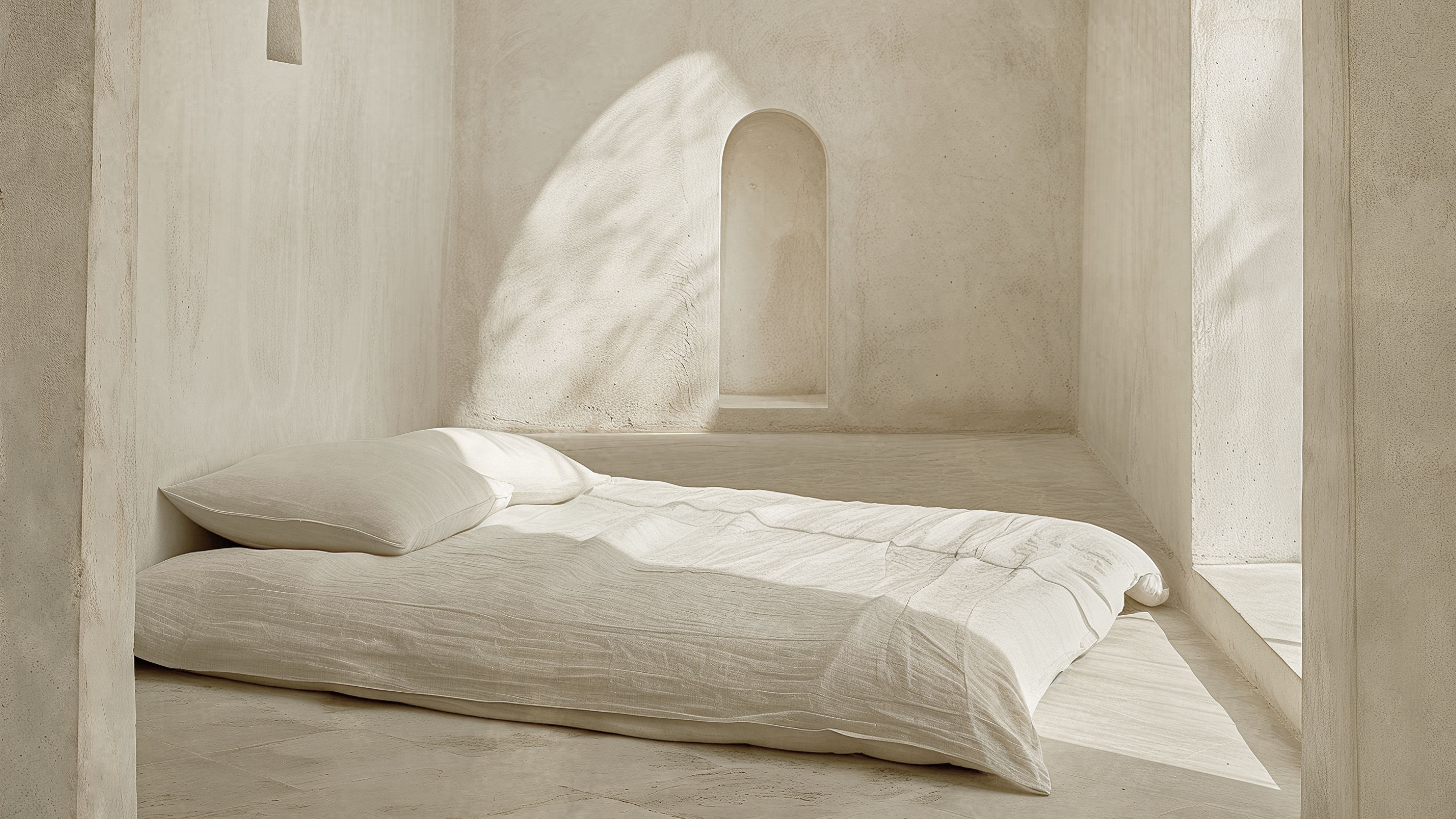 Bedroom with limewash walls and a bed without a frame