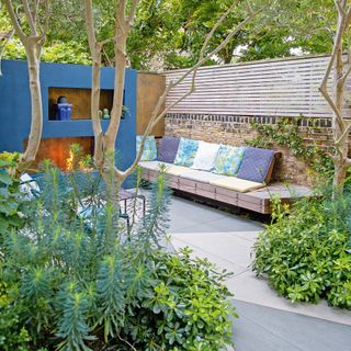 courtyard garden with blue fireplace and outdoor sofa