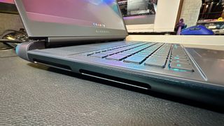 A close-up photo of the left side of the Alienware 18 Area-51 gaming laptop, showing the exhaust vents for the cooling system