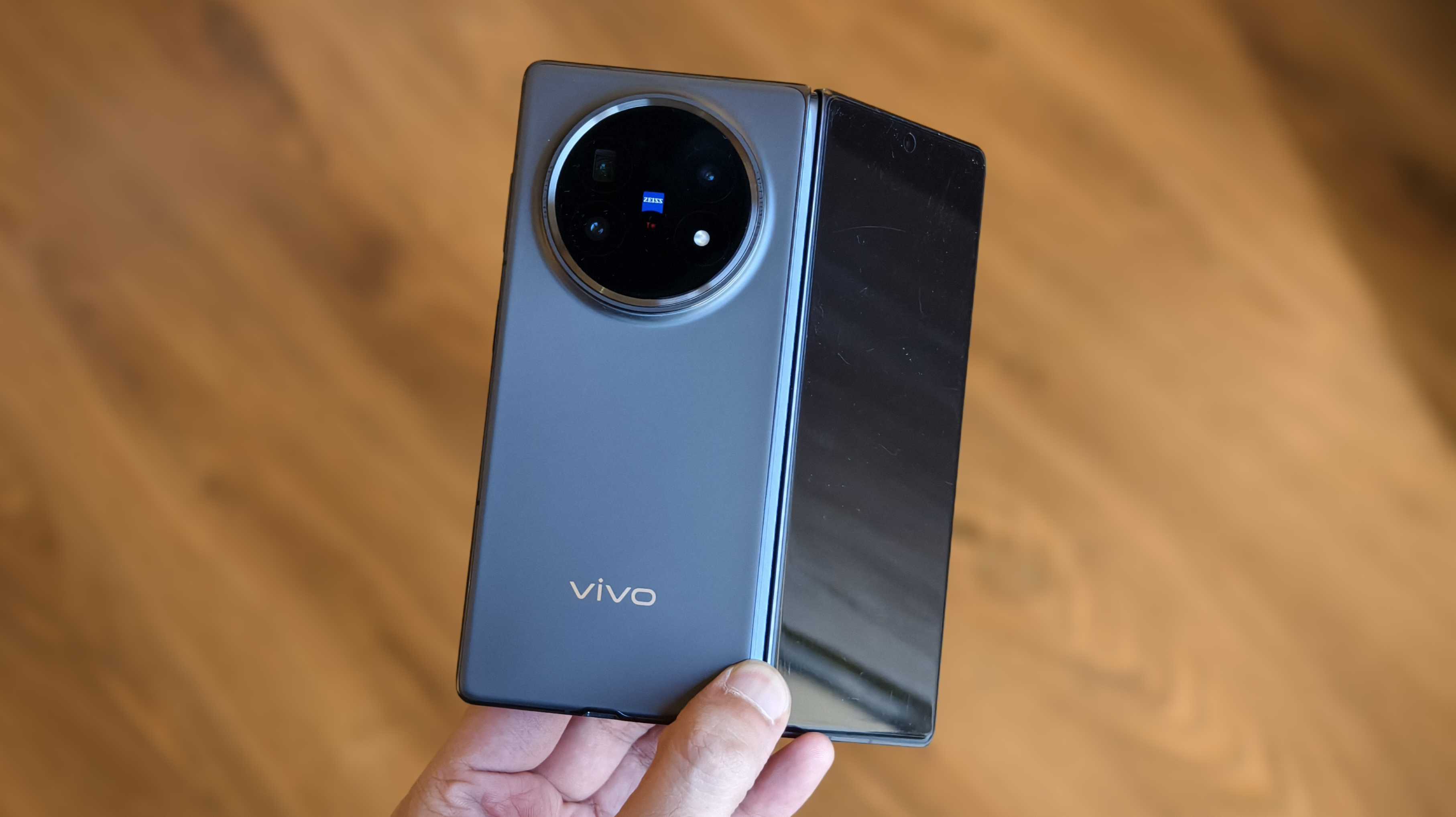 Prakhar holding a half-folded Vivo X Fold 5.