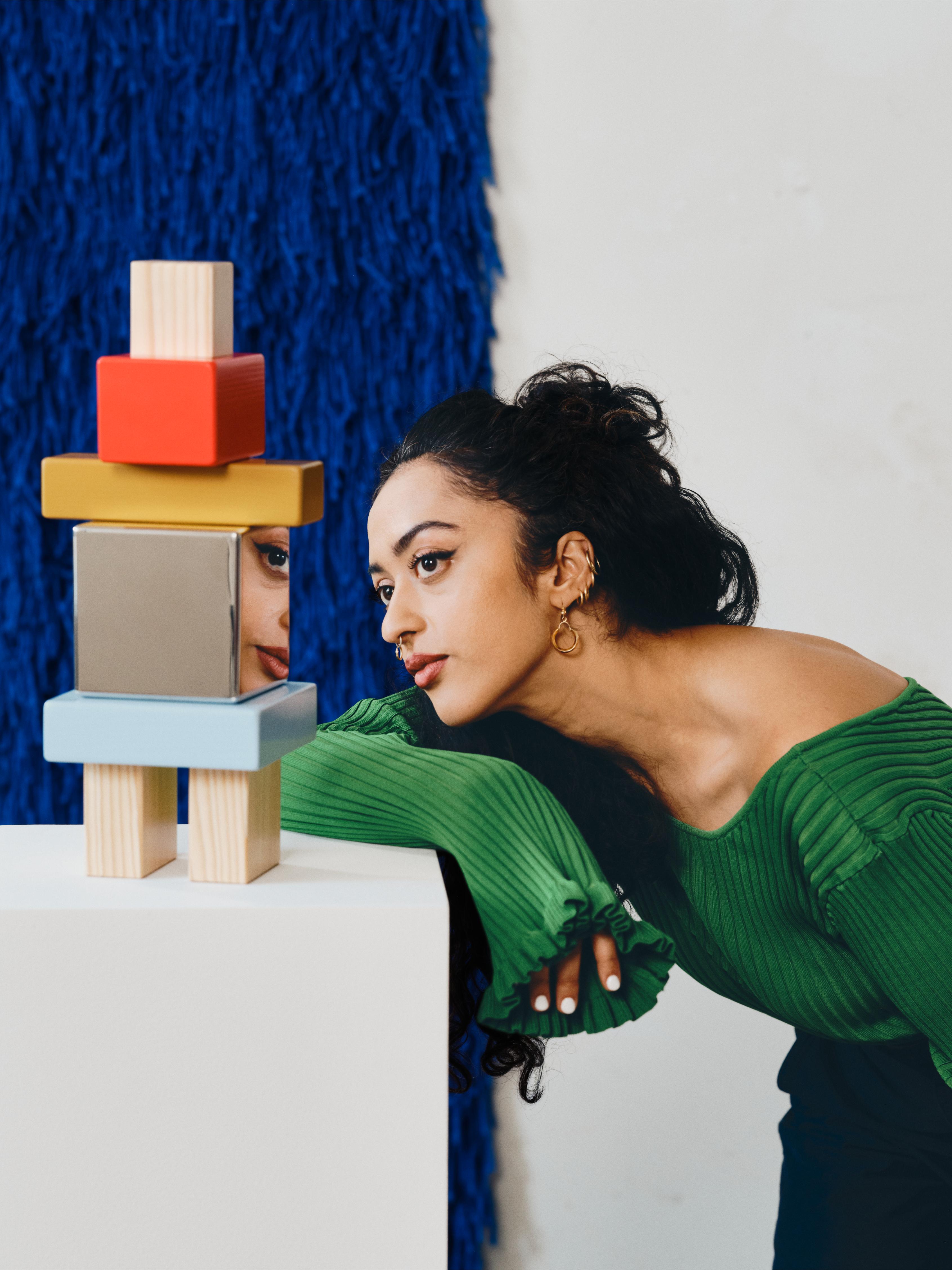 Akanksha Deo next to her totemic sculpture for IKEA