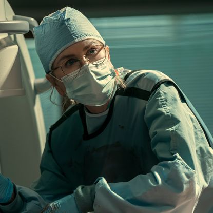nicole kidman as kay scarpetta in scrubs and a mask doing an autopsy in prime video's scarpetta