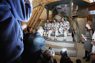 ESA Astronaut Paolo Nespoli and his fellow Soyuz TMA-20 crewmates meet the press at Star City following completion of their exam in the Soyuz capsule simulator on Nov. 25, 2010. Left to right Catherine Coleman, Dmitri Kondratyev and Paolo Nespoli. The Soy