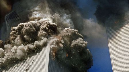 The south tower of the World Trade Center, left, begins to collapse in New York Tuesday Sept. 11. 2001