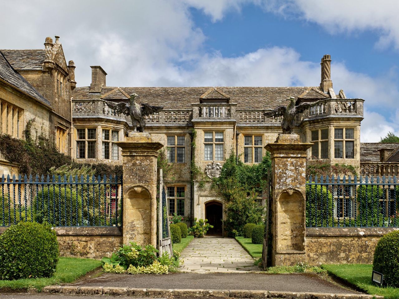 Fig 1: The main front and gates, with eagle-topped piers, of the manor house. Mapperton House — ©Paul Highnam / Country Life