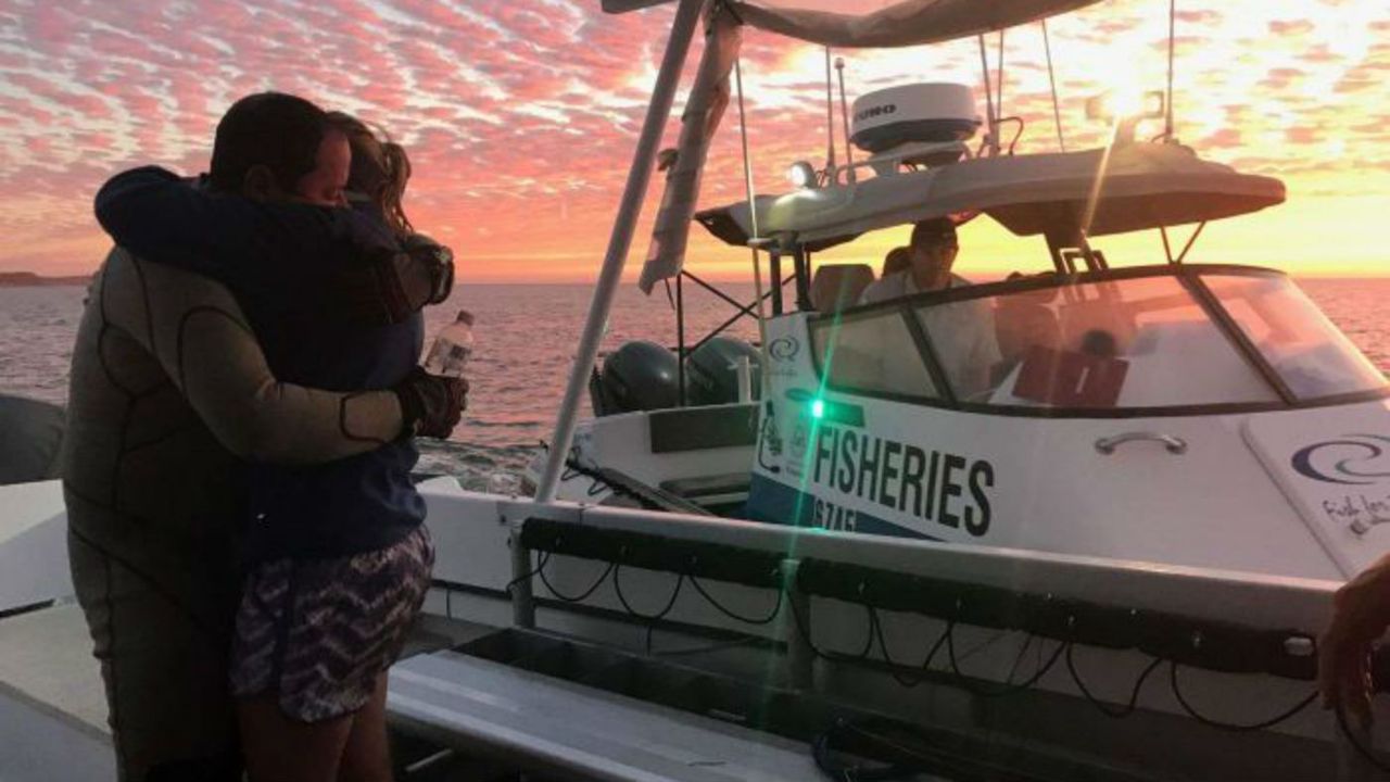 John Craig embraces his wife after being rescued