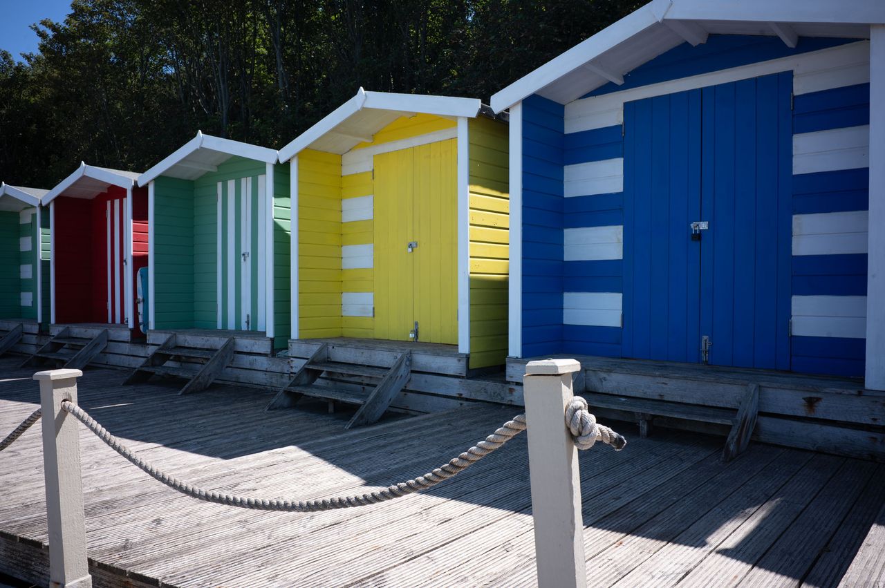 Colourful beeach huts on a sunny day