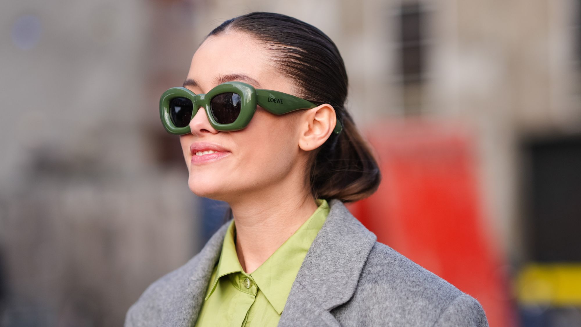 brunette woman wearing green loewe sunglasses
